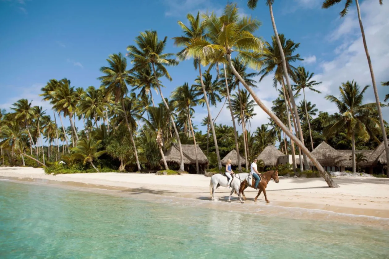 Horseback riding on beach at Como Laucala Island